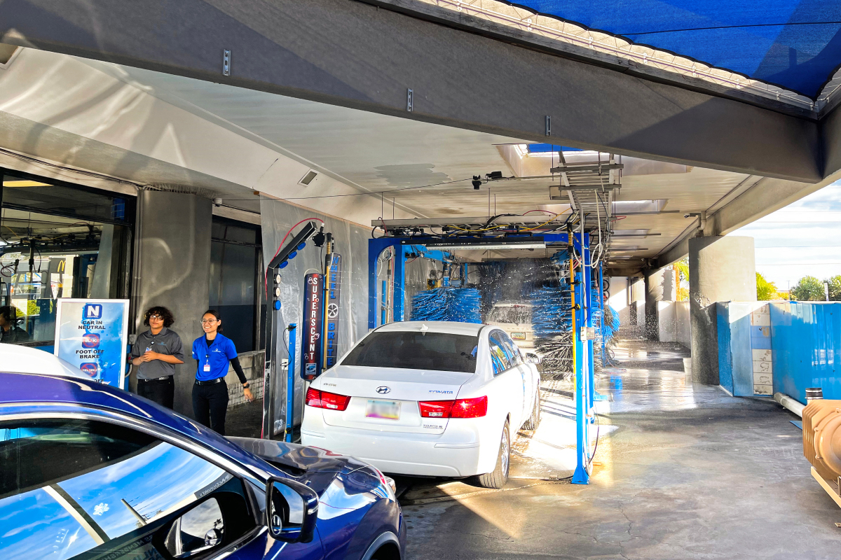 car inside a touchless car wash tunnel